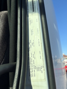 Vehicle identification label on door jamb of a Volvo VNL64T860 showing VIN 4V4NC9EJ3RN654630 and other specification text (sticker view).