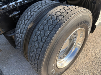 Volvo VNL64T860 truck rear dual tires showing Bridgestone tire brand and chrome wheel.