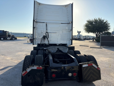 Volvo VNL64T860 semi truck rear view showing fifth wheel, dual rear axles, and tail sections with mud flaps and lights.