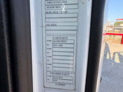 Vehicle identification tag labels on a Volvo truck door frame showing paint and axle information blocks.
