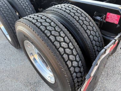 Tandem rear tires on a Volvo VNL truck showing dual wheel setup and tread pattern.
