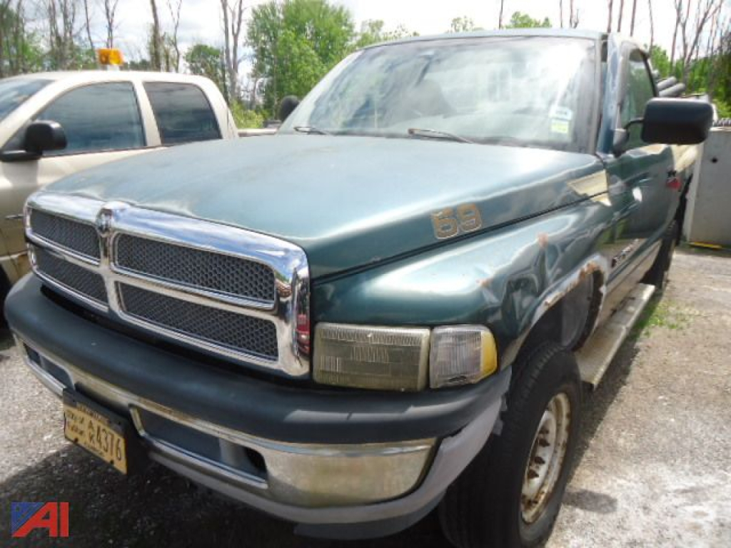 Dodge Ram 2500 pickup truck with green body and chrome grille, front bumper, and 4x4 badge; appears used with a license plate visible.