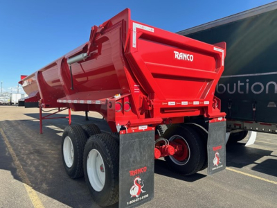 Ranco Ed26-34 dump trailer rear-right view showing red steel dump body, dual rear axles, white wheels, and RANCO branding.