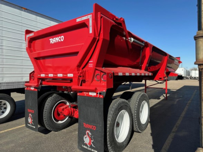 Ranco ED26-34 dump trailer in red with dual rear axles and brand name RANCO visible on side and tailgate.
