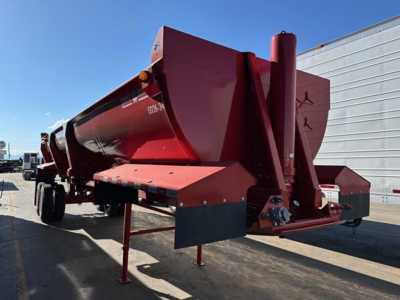 Dump trailer showing Ranco Ed26-34 with red body and hitch, side view, DOT lights, support legs down, new condition, white lettering along tank.