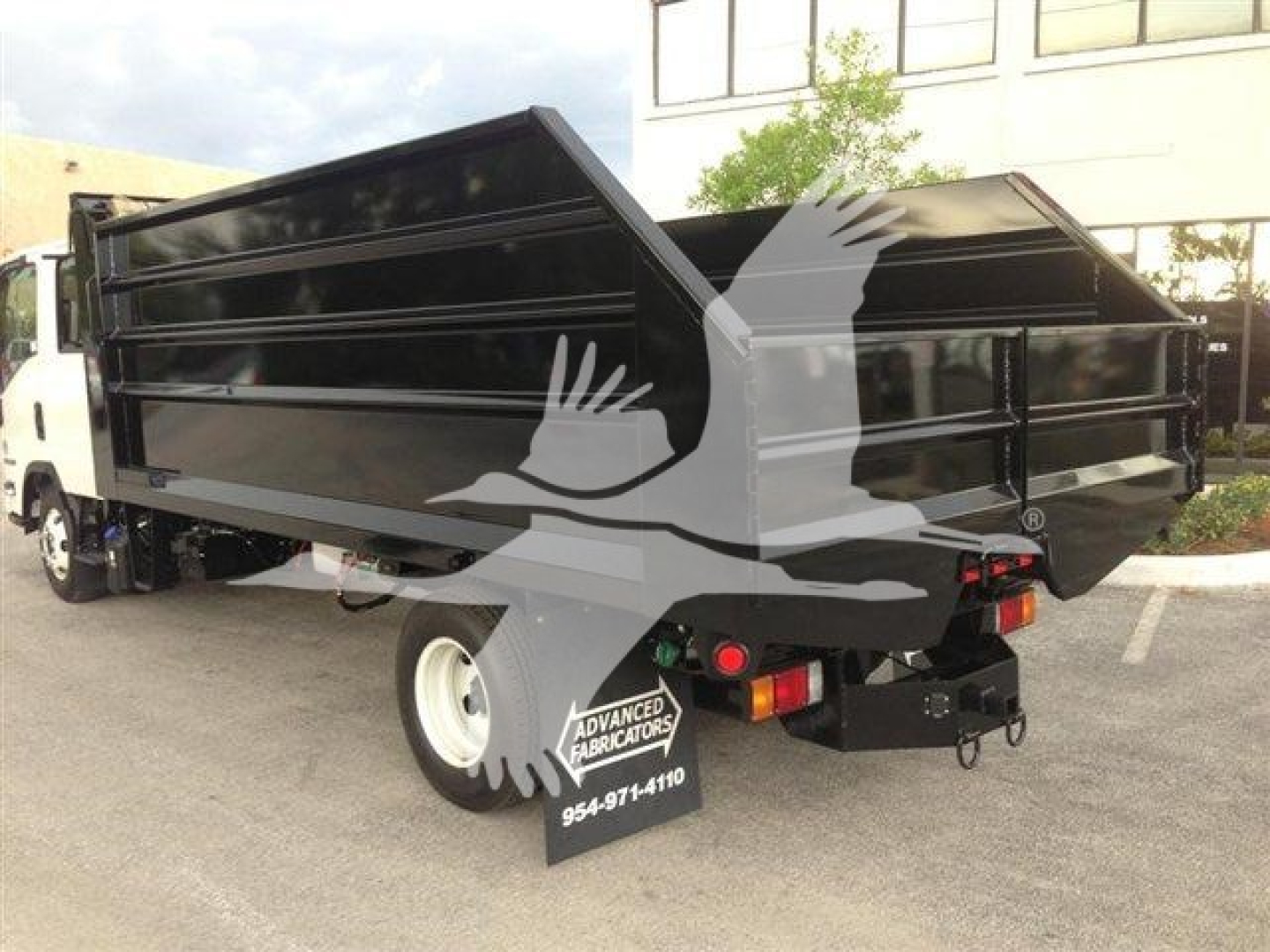 Dump truck bed on a 2026 Advanced Fabricators 14 ft dump truck showing black steel dumping body with tailgate and rear lights.