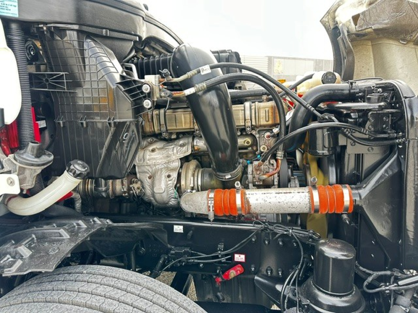 Freightliner Cascadia 126 engine bay showing turbo hoses and components.