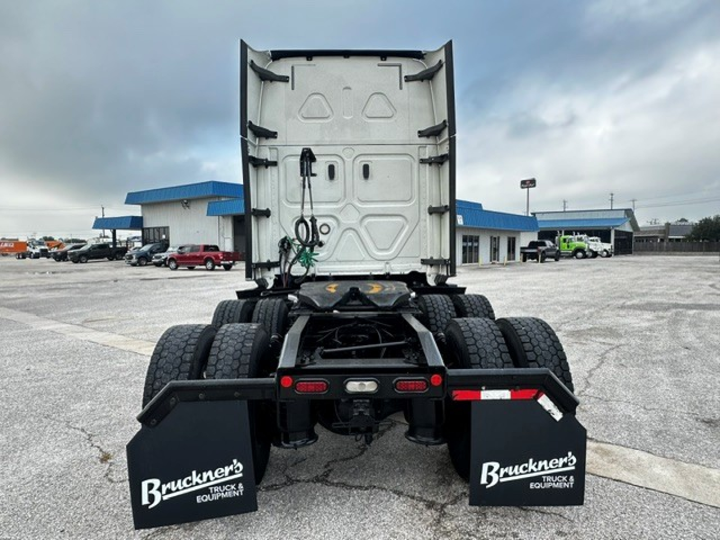Freightliner Cascadia 126 tractor rear view showing fifth wheel and mud flaps with Bruckner's Truck Equipment branding.