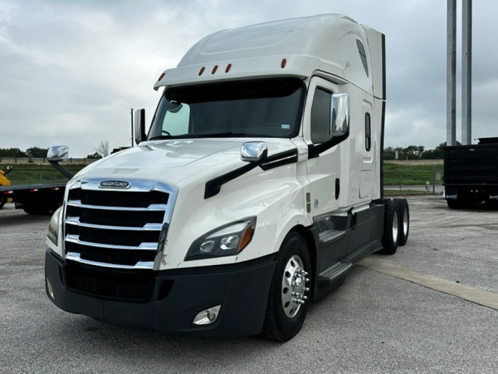 Freightliner Cascadia 126 semi-truck in white with sleeper cab, front view.
