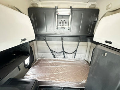 Freightliner Cascadia 126 sleeper cab interior cargo area with bed and storage compartments visible.