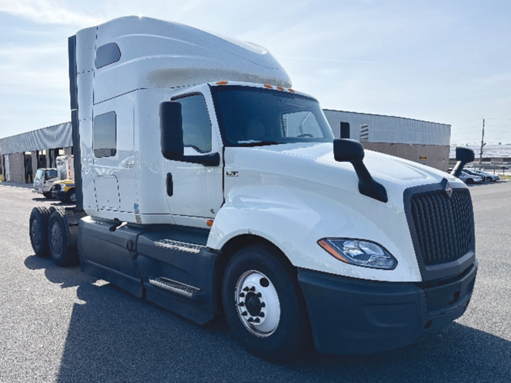 International LT Series heavy-duty truck cab and chassis with sleeper, white exterior, front grille, headlights, and side mirrors.