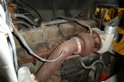 Mack R690T engine bay showing intake manifold and turbocharger assembly.