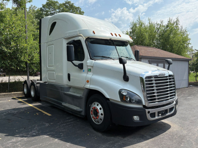 2018 Freightliner Cascadia125 tractor-trailer with sleeper cab, white exterior, parked in lot.