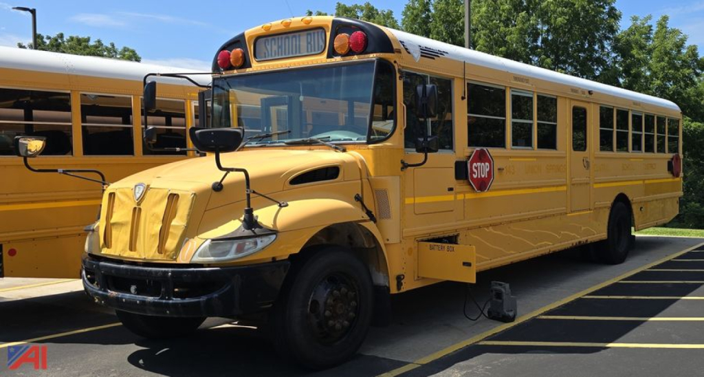 School bus front-left view showing yellow IC Corporation International CE Series bus with stop sign and hood vents.