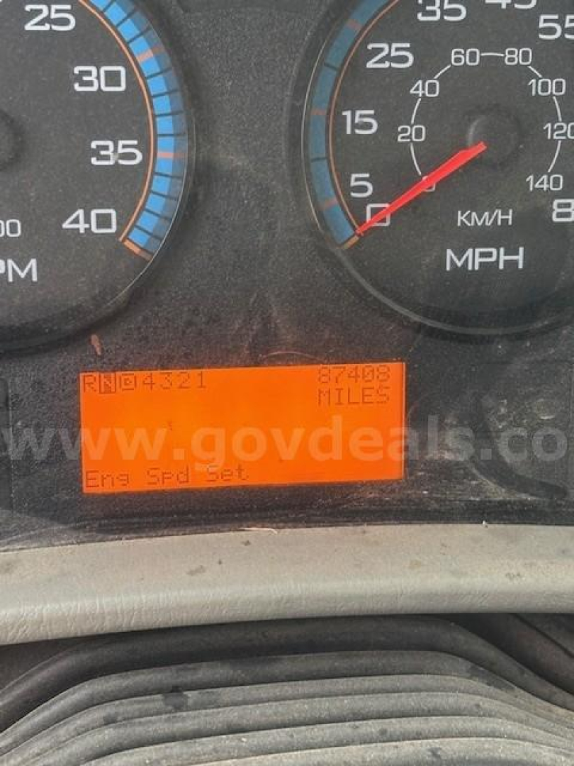 Dashboard view showing orange digital display with mileage and text, speedometer and tachometer gauges in a 2019 International DuraStar 4300 truck.