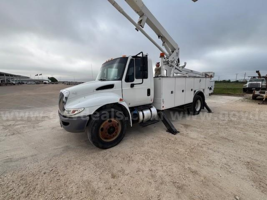 Truck bucket lift apparatus showing 2019 International DuraStar 4300 with bucket truck equipment and utility compartments.