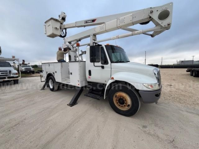 2019 International DuraStar 4300 bucket truck with aerial lift, white cab and boom, hydraulic stabilizers deployed. Visible text on boom reads 'Terex' and there is a small label on side with model details.