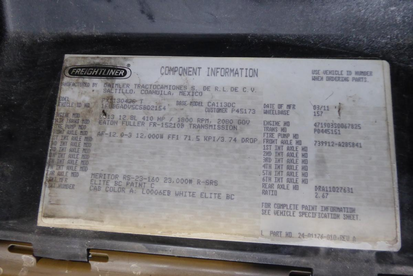 Freightliner component information plate on a 2012 Cascadia 113 daytime cab. Shows VIN 1FUBGADV5CSBD2154, stock 0323233, body/build specs, paint code, cab color, and other vehicle identifiers.