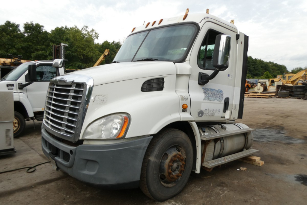 Freightliner Cascadia 113 conventional daycab truck side view showing front grille, windshield, and fuel tanks.