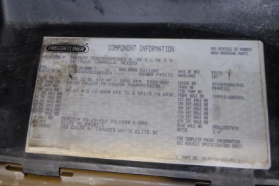 Freightliner component information plate on a 2012 Cascadia 113 daytime cab. Shows VIN 1FUBGADV5CSBD2154, stock 0323233, body/build specs, paint code, cab color, and other vehicle identifiers.