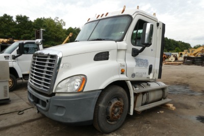 Freightliner Cascadia 113 conventional daycab truck side view showing front grille, windshield, and fuel tanks.