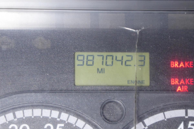 Dashboard odometer reads 987042.3 miles with engine gauge; brake light indicators on right side.
