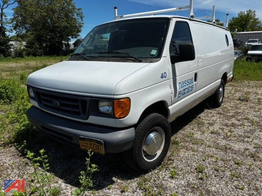 Ford E350 cargo van in-service showing front-left view with NASSAU-BOYS or BOCES logo on side and roof ladder rack.