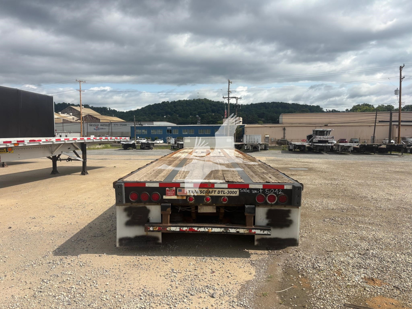 Transcraft DTL-3000 drop deck trailer rear view showing taillights and bumper.