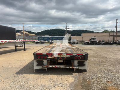 Transcraft DTL-3000 drop deck trailer rear view showing taillights and bumper.