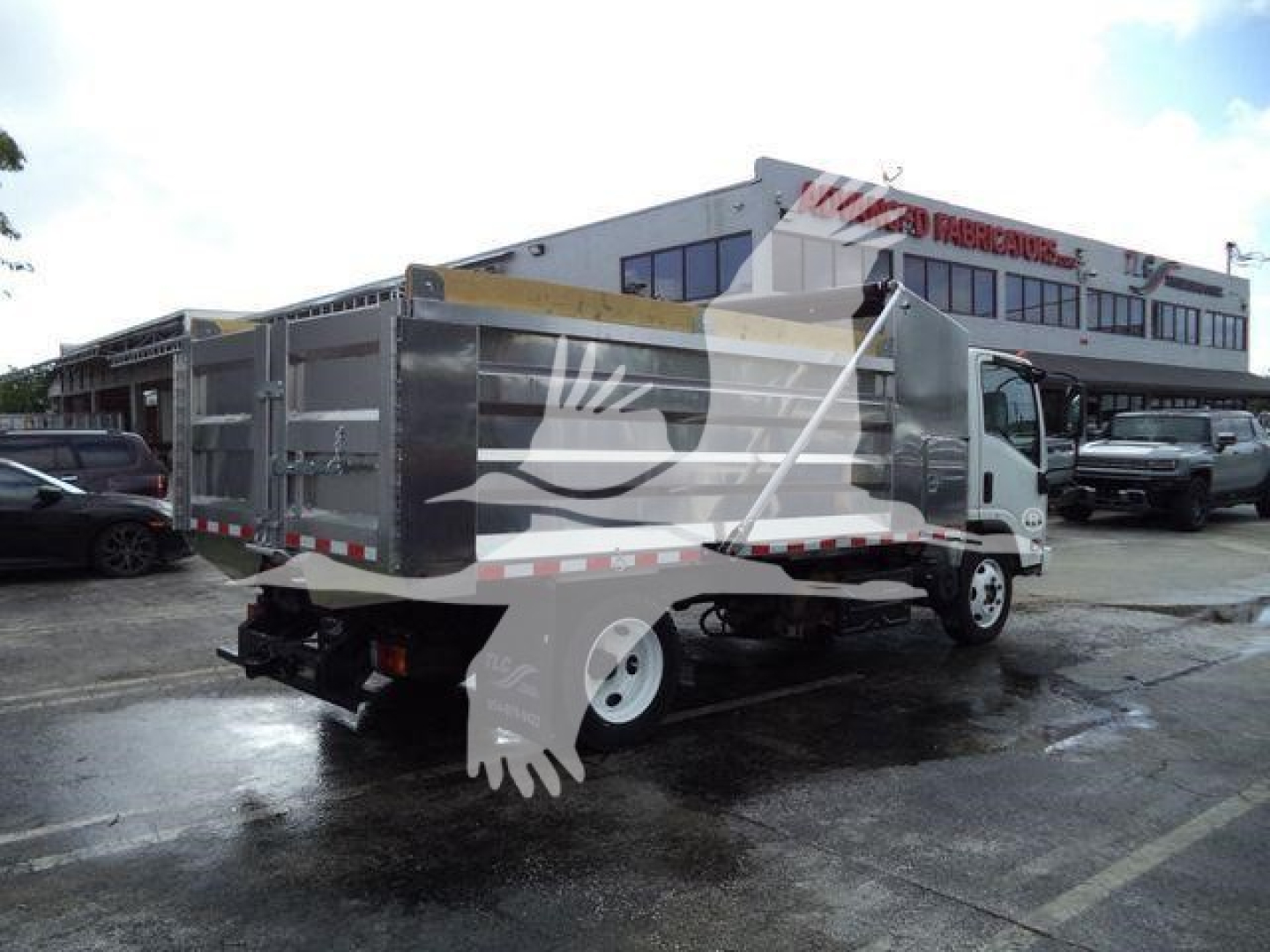 Isuzu NPR XD dump truck side/back view showing cargo bed and branding not legible.
