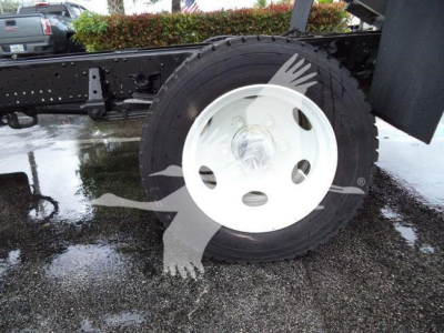 Isuzu NPR XD truck chassis showing single rear wheel with white steel rim and black tire, undercarriage frame visible.