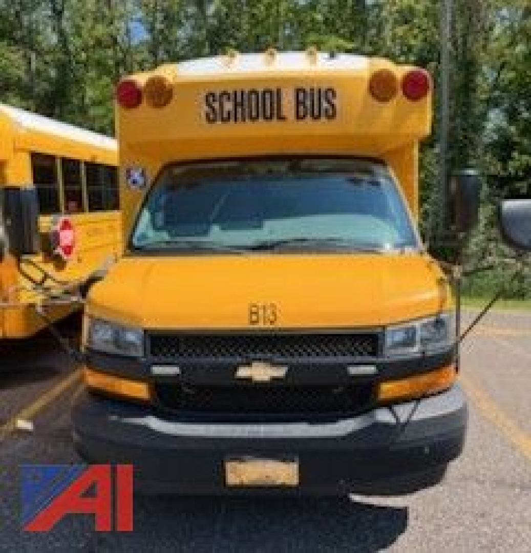 Front view of a yellow 2018 Chevrolet Transit Express School Bus with a wheelchair lift, showing 'SCHOOL BUS' on the roof, Chevrolet emblem, and B13 on the hood.