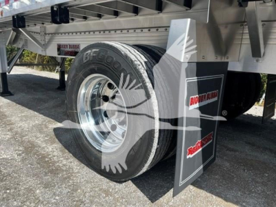Trailer wheel and mud flap showing Big Bubba branding and BF Goodrich tire on a flatbed trailer (new) with chrome wheel and metal frame.