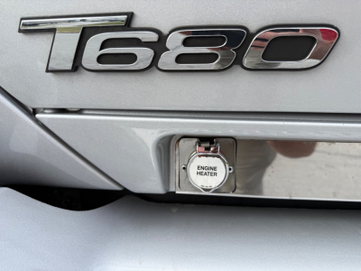 Kenworth T680 engine heater cap visible on rear of cab with 1680 badge behind.