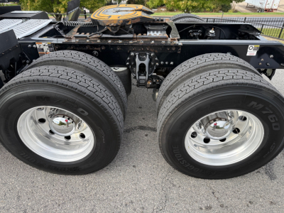 Kenworth T680 chassis showing dual rear wheels and undercarriage components with chrome wheels and tires.