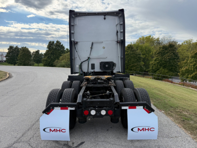 Kenworth T680 rear view showing chassis without trailer, dual rear axle, mud flaps with MHC logo, tail lights, and fifth wheel area.