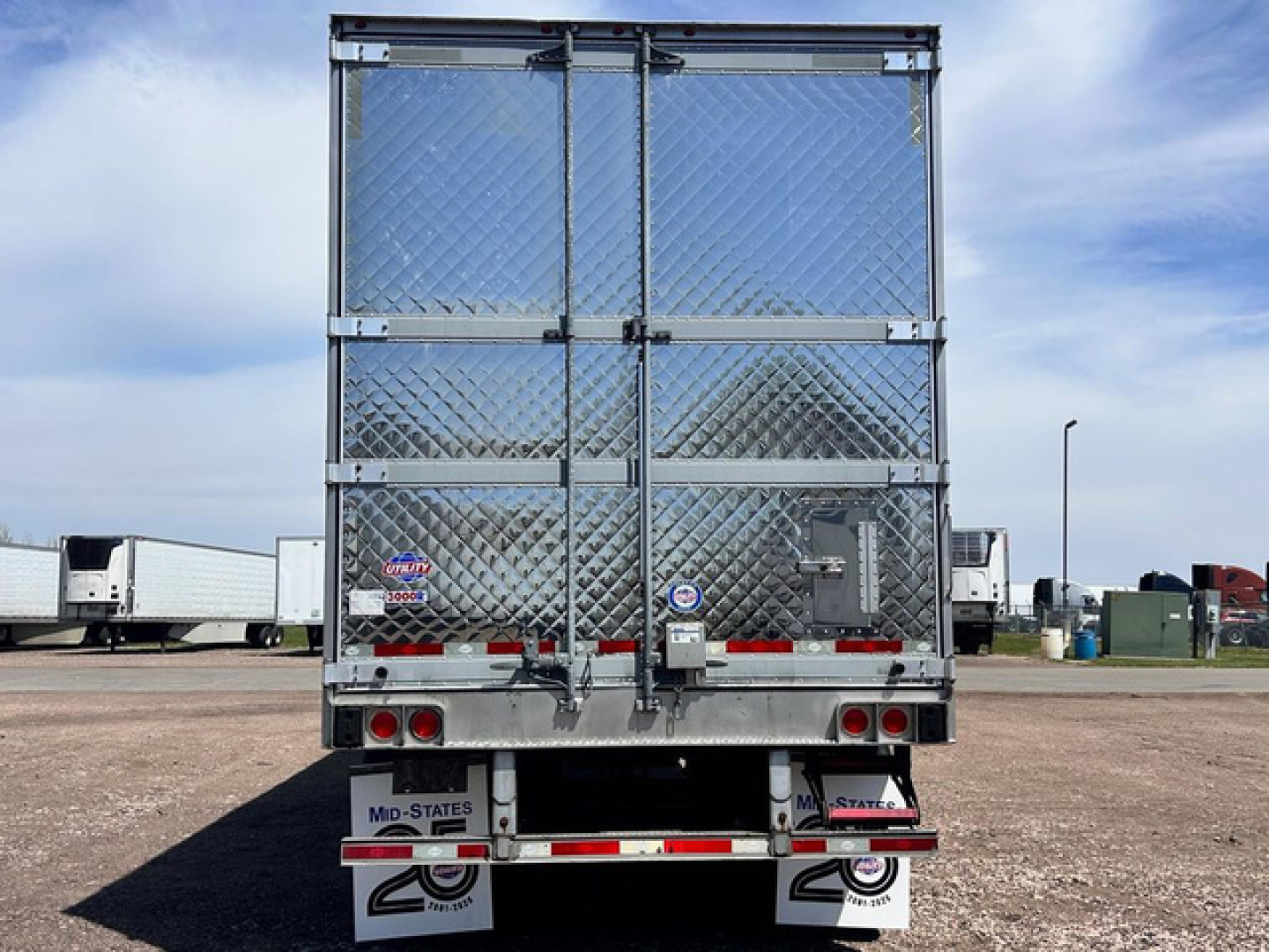 Back view of a 2022 Utility Reefer trailer showing diamond plate doors, rear lights, and bumper with reflectors.