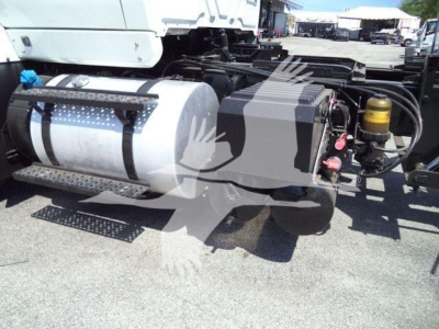 Truck chassis showing aluminum fuel tank and hydraulic components on International Workstar rollback truck.