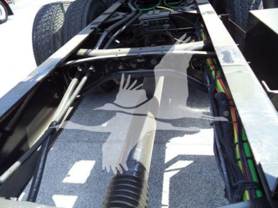 Truck chassis with hydraulic lines and dual tires visible, cabling and frame rails in view, 2016 International Workstar part of rollback truck.