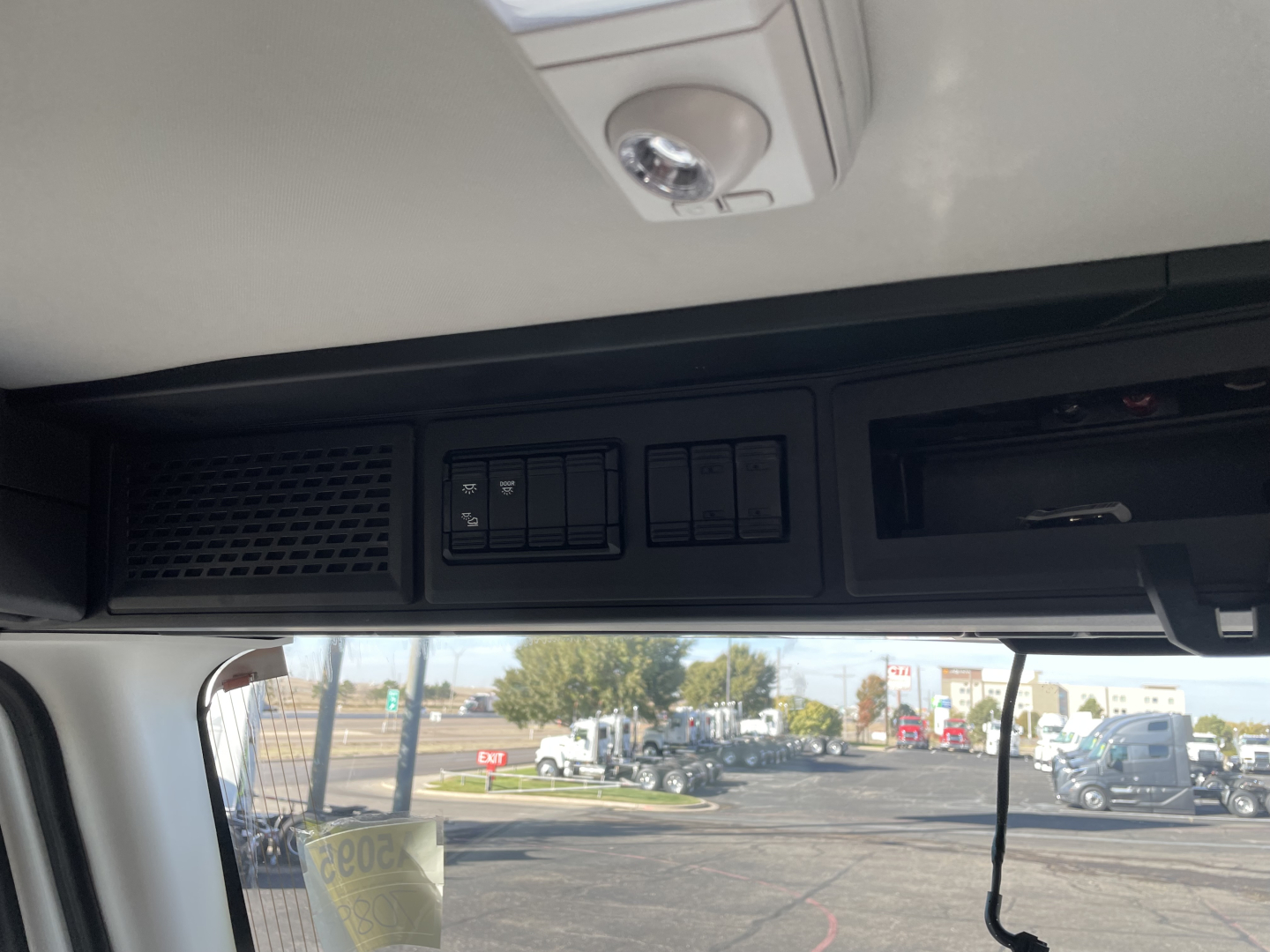 Dashboard area of a 2026 Mack PR64T truck showing switches and vents; no specific model text visible on dashboard portion.