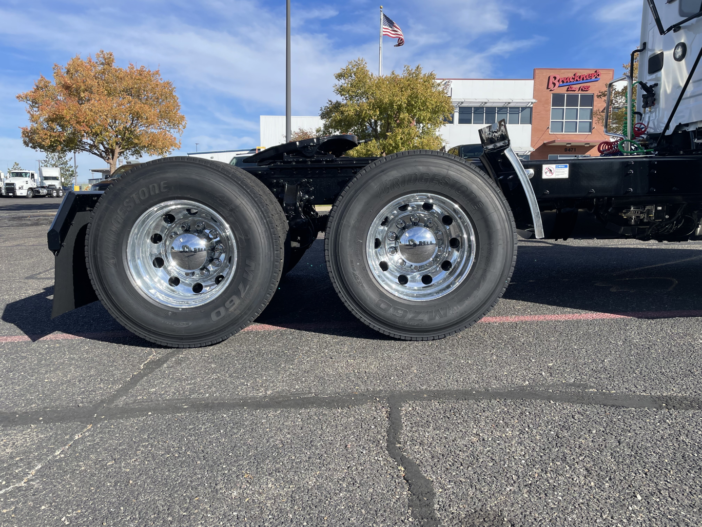 Mack PR64T heavy-duty truck chassis showing dual rear axles with polished aluminum wheels and tires mounted.