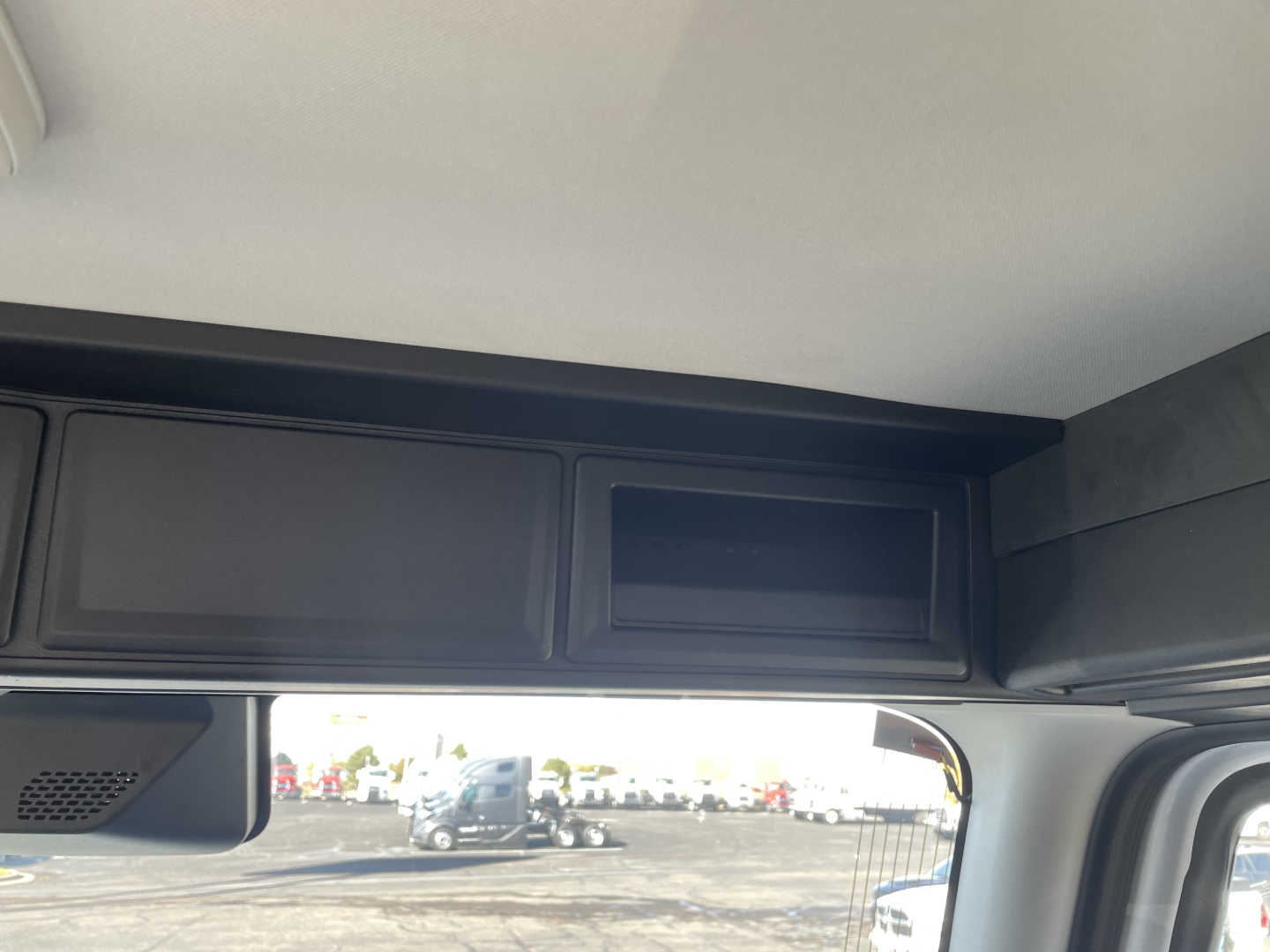 Mack PR64T truck cab interior/storage compartment area view from windshield.