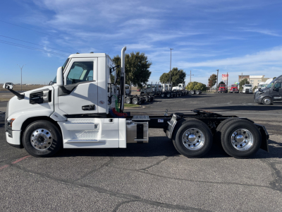 White 2026 Mack PR64T conventional daycab tractor side view showing cab, fuel tanks, and dual rear axles.