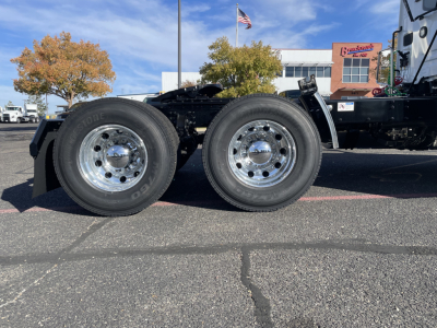 Mack PR64T heavy-duty truck chassis showing dual rear axles with polished aluminum wheels and tires mounted.