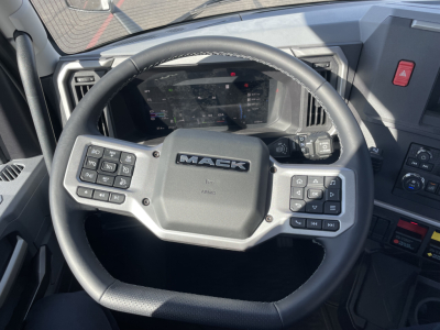 Mack PR64T truck interior steering wheel with integrated controls and digital instrument cluster visible.