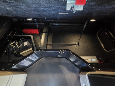 Interior storage area of 2024 Kenworth W990 with cockpit floor and side compartments visible