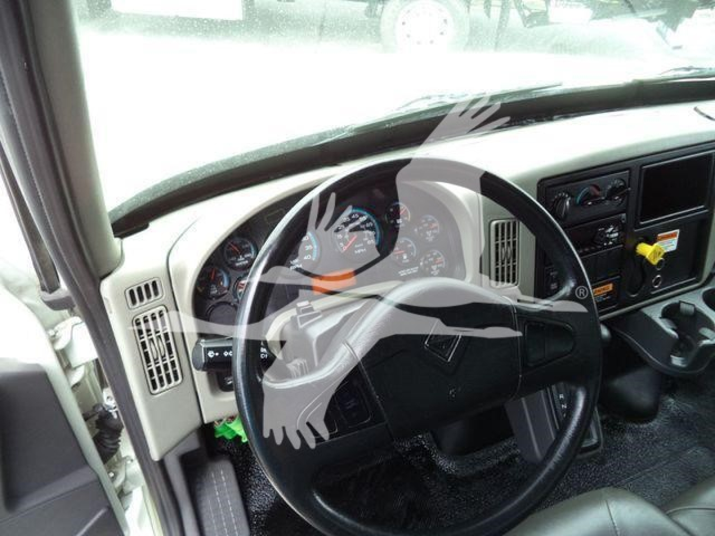 Truck interior: steering wheel and dashboard of a 2019 International 4300 with gauges and controls visible