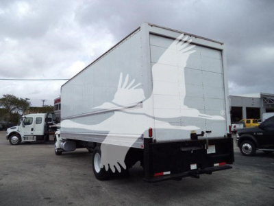 Box truck rear and side view with white cargo box, International 4300 stock photo; no legible text visible on the truck itself.