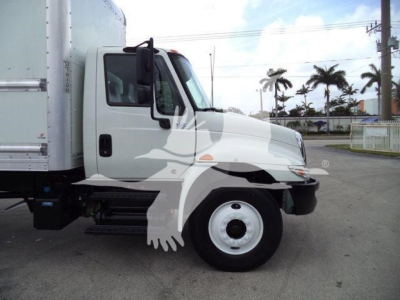 Side view of a white 2019 International 4300 box truck showing cab with black mirrors and wheel, with stock info overlay.