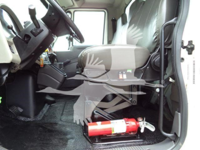 Cab interior of a 2019 International 4300 box truck showing driver's seat, steering wheel, dashboard, and a red fire extinguisher under the seat area.
